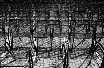 Close-up on rows of rebar and wire mesh chairs. Black and white photo.