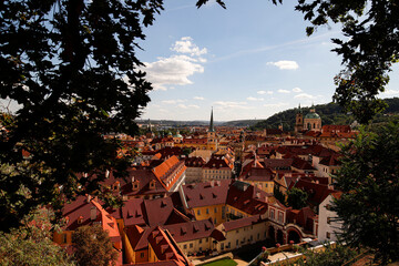 Panorama of Prague, from Petr&iacute;n Hill, characteristic red roofs and in the background, blue sky with white clouds.