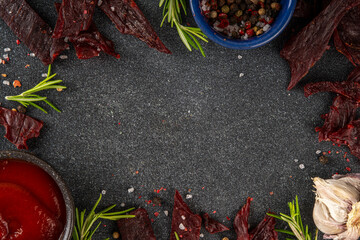 Dried meat snack, jerky beef meat. Healthy beef meat snacks, with sauce and spices on serving...