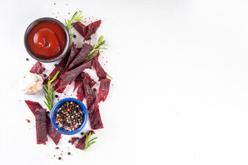 Dried meat snack, jerky beef meat. Healthy beef meat snacks, with sauce and spices on serving...