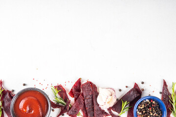 Dried meat snack, jerky beef meat. Healthy beef meat snacks, with sauce and spices on serving...
