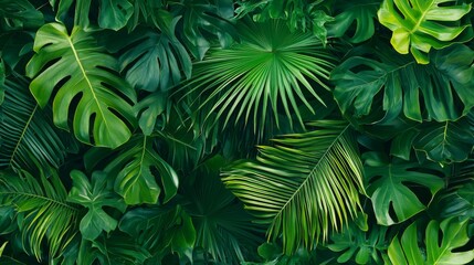 Tropical foliage featuring palm leaves and exotic plants. Vibrant green wallpaper seamless pattern