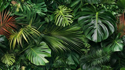Tropical foliage featuring palm leaves and exotic plants. Vibrant green wallpaper seamless pattern
