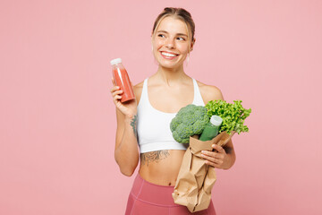 Young happy woman wear white top casual clothes hold packet with vegetables, bottle orange juice...