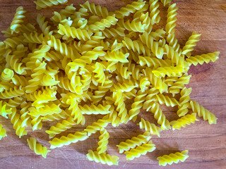 raw screw pasta dough on wooden background