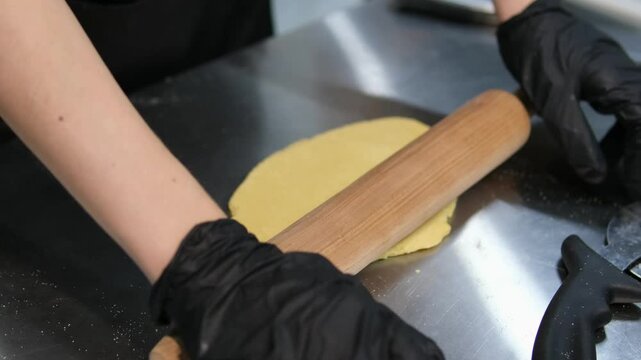 black fart and latex chef gloves knead thick dough with your hands Kneading Pizza Dough by Hand on a White Table Top