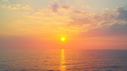 Obraz premium A golden sunset illuminating the horizon over a vast ocean, casting a warm and radiant glow across the water, showcasing the serene beauty of nature 