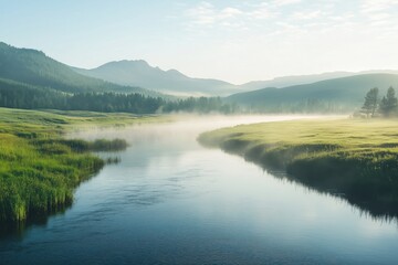 A calm river flows through a lush green valley surrounded by mist-covered mountains. The tranquil waters reflect the vibrant greenery and the mist, creating a peaceful, dreamlike atmosphere. 