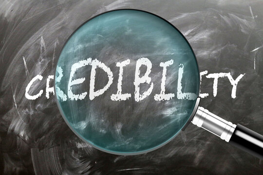 Credibility - learn, study and inspect it. Taking a closer look at credibility. A magnifying glass enlarging word 'credibility' written on a blackboard ,3d illustration
