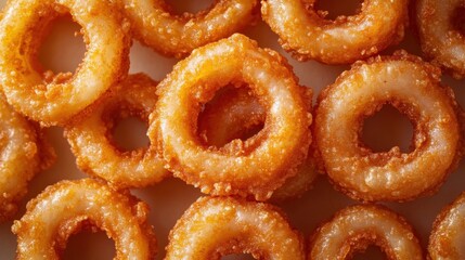 Close-up of fried onion rings, overlapping each other, looking delicious. It is an easy-to-eat food that can be eaten as a snack or between meals.