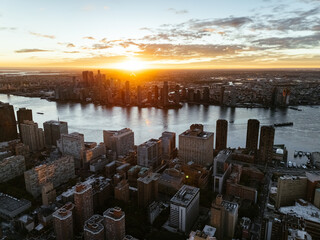 An aerial photo of Manhattan's downtown, East river, and Brooklyn from above during the sunrise...
