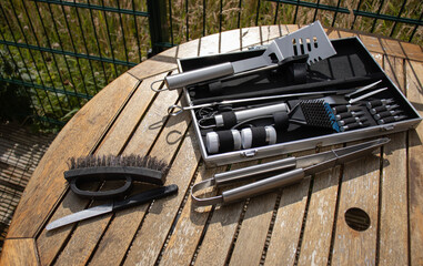 Barbecue tools close up. Set of cooking tools. Metal tongs and spatulas. Homemade food