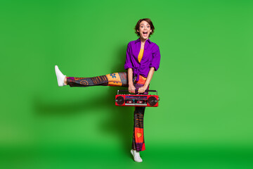 Photo of young woman holding boombox in purple stylish shirt and brown bob haircut dancing so funny...