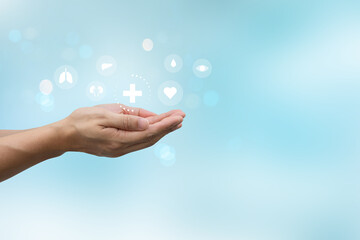 close up man hand gesture and show about internal organ of human cell on blur blue background for human kindness of living and donation medical nonprofit concept