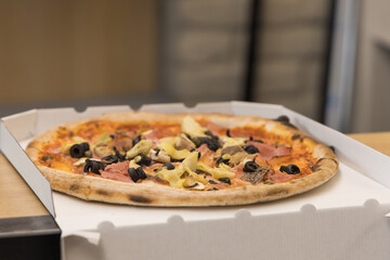 Excellent pizza in a box for sale across the street