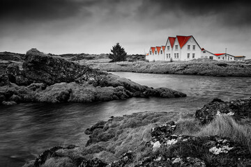 typical red Icelandic houses on the coast Straumur