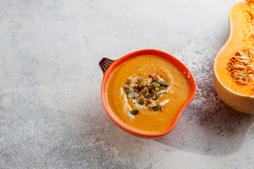 Traditional autumn butternut squash soup with seeds.