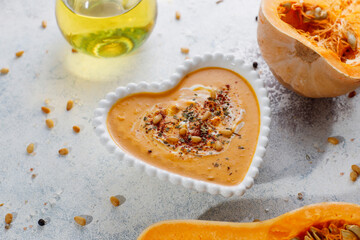 Traditional autumn butternut squash soup with seeds.