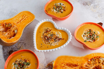 Traditional autumn butternut squash soup with seeds.