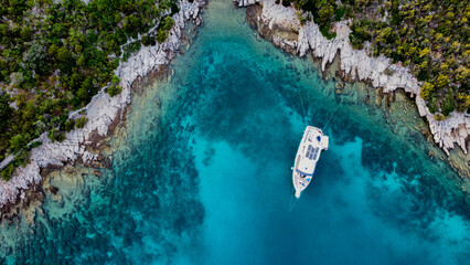 Aerial view from above of a large eco-friendly yacht with solar panels receiving energy during the...