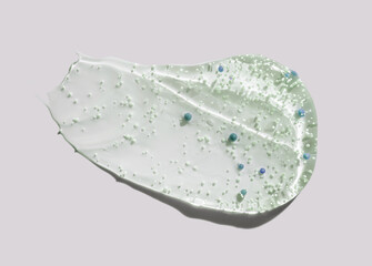 Cosmetic transparent peeling scrub with micro capsules swatch isolated on light gray