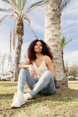 Young afro girl smiling looking to the camera very happy in summer time