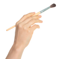 Woman hand holds paint brush, isolated on transparent background, painting and design concept