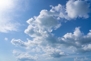 Beautiful blue sky and clouds natural background. Cumulus clouds in the blue sky. White fluffy clouds on blue sky in summer. 