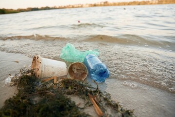 Trash on the shore, conception of the ecology and Earth day