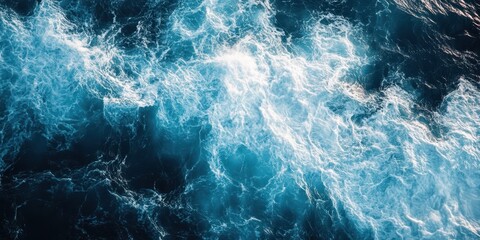Fototapeta premium A stunning aerial view of swirling ocean waves, showcasing vibrant textures and shades of blue and white, evoking a sense of tranquility.
