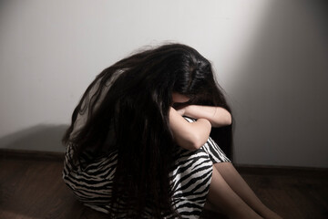 Teenager girl with depression sitting alone