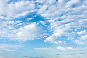 Fluffy cumulus clouds drift against a vibrant blue sky, a breathtaking natural spectacle