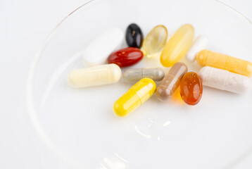 Close up of Small Dish with Various Vitamin Supplements