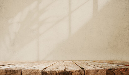 Top wooden table with beige wall texture background for mocking up or display product to make...