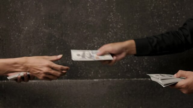 Businessman giving money to partner. Businessman giving bribe money to partner in dark room for corruption and and bribery concepts.