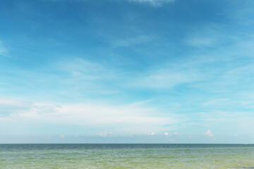 Serene seascape with calm ocean waters meeting a clear blue sky. The horizon line blends smoothly, creating a peaceful and tranquil natural scene. Perfect for backgrounds, travel, and nature.