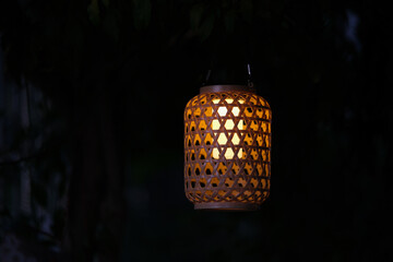 Lamp hanging on a tree in a dark corner