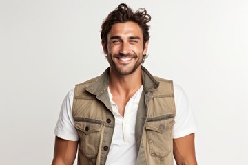 Fototapeta premium Portrait of a grinning man in his 30s wearing a rugged jean vest isolated on white background