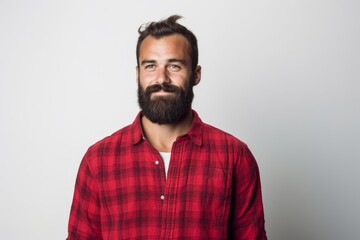 Obraz premium Portrait of a tender man in his 30s dressed in a relaxed flannel shirt isolated on white background