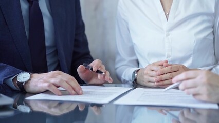 Diverse business people discussing contract terms before signing the agreement. Teamwork of lawyers...