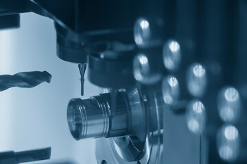 The CNC lathe machine swiss type  hole drilling process on the metal shaft parts.