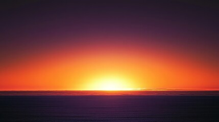 Obraz premium A vibrant orange sunset over the ocean with a deep purple sky.