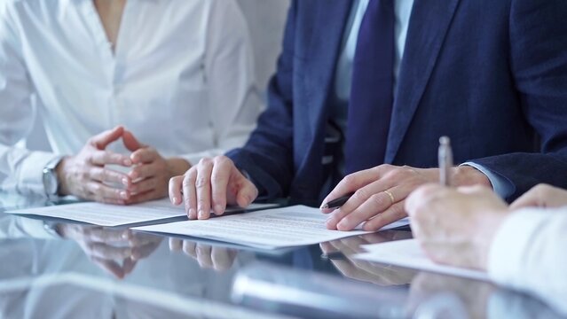 Business people and lawyers a contract papers before signing the agreement. Teamwork concept