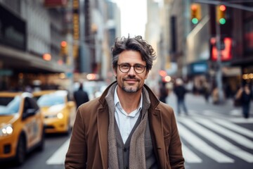 Obraz premium Portrait of a content man in his 40s wearing a chic cardigan while standing against busy urban street