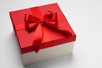 Gift box with bow on light grey background