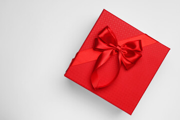 Gift box with bow on light grey background, top view. Space for text