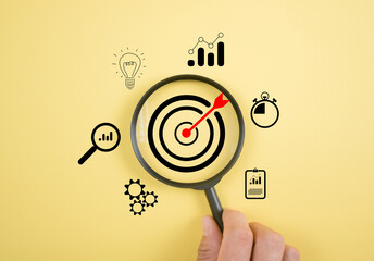 Magnifier glass focus on target dartboard, Business development strategy, and action plan concept...