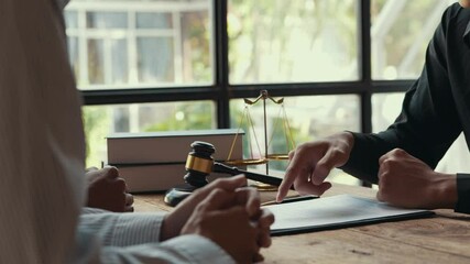 Lawyer explaining a contract to a businessman, leading to agreement and a handshake in a professional office setting