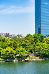 Scenic scene with modern glass skyscrapers seen from the Osaka Castle park , Japan.
