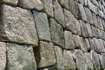 Traditional japanese stone wall moat at the base of Osaka Castle. Texture background.